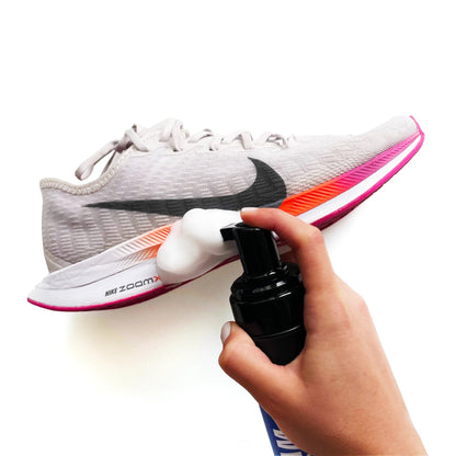 Person Using Shoe Cleaner Foam to Clean Sneakers